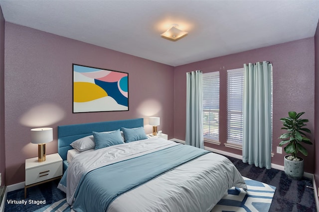 bedroom with dark colored carpet