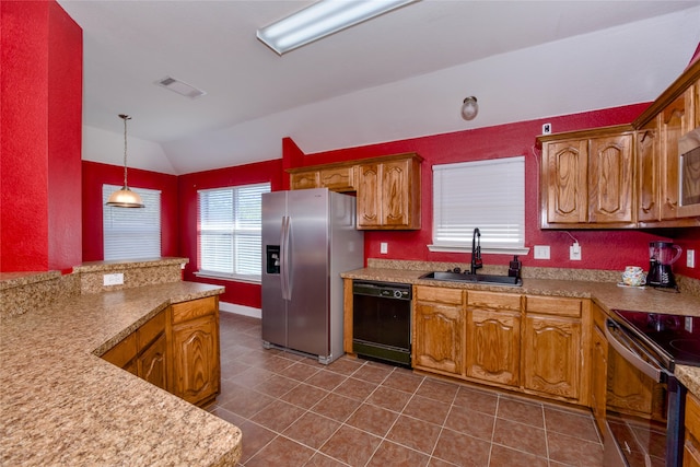 kitchen with appliances with stainless steel finishes, hanging light fixtures, vaulted ceiling, dark tile patterned flooring, and sink