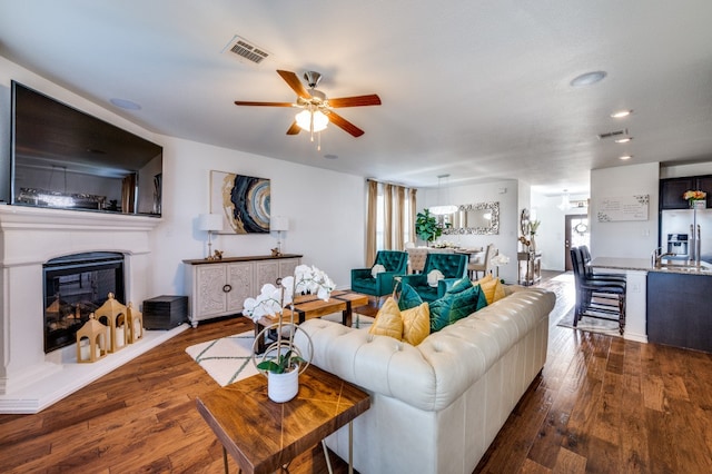 living room with ceiling fan and hardwood / wood-style floors