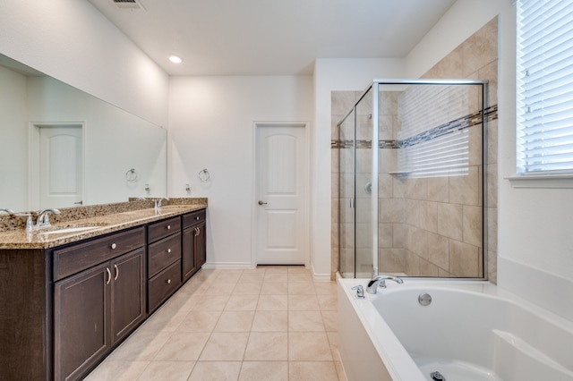 bathroom with tile patterned flooring, independent shower and bath, and vanity