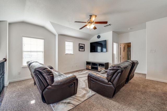 living room with lofted ceiling, ceiling fan, and carpet floors