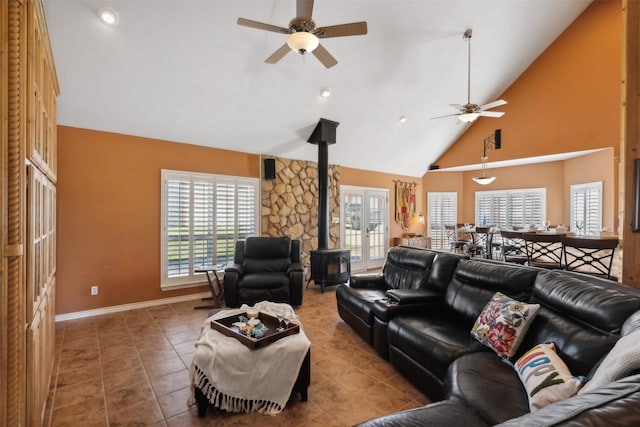 tiled living room featuring french doors, high vaulted ceiling, a wood stove, and ceiling fan