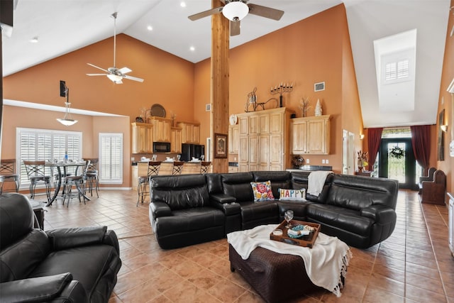 living room featuring ceiling fan, light tile patterned floors, and high vaulted ceiling