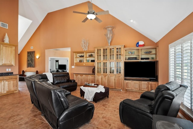 living room featuring high vaulted ceiling, ceiling fan, and light tile patterned flooring