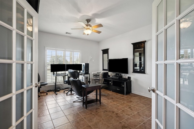 office space with visible vents, a ceiling fan, dark tile patterned floors, and french doors