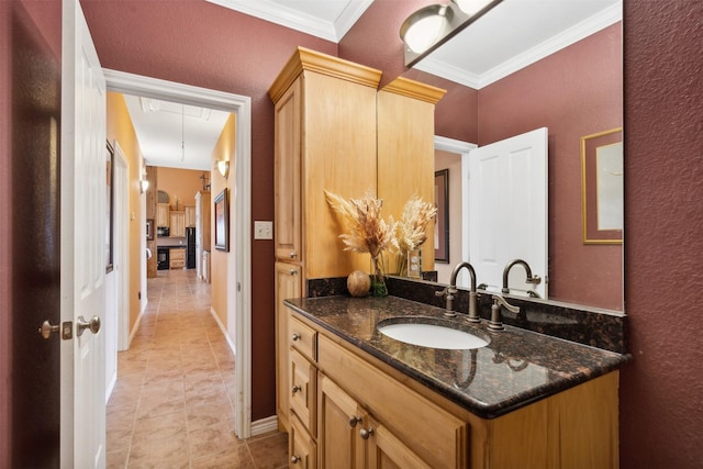 bathroom with vanity and ornamental molding