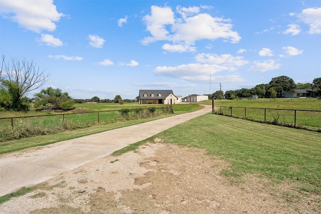 view of home's community with a yard and a rural view