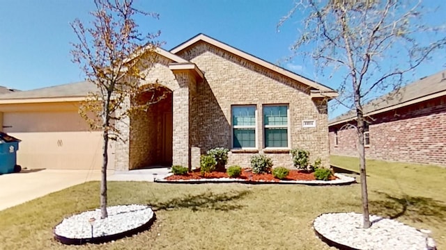 view of front of house featuring a garage and a front lawn