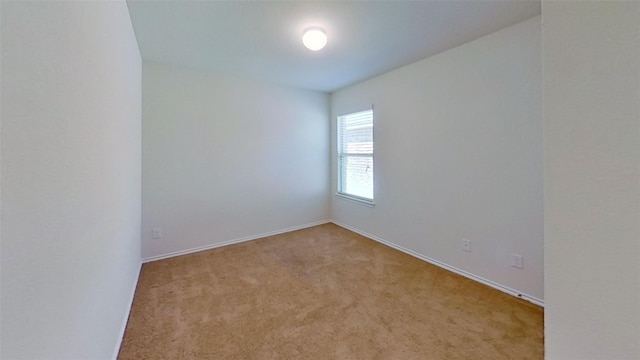 unfurnished room featuring light carpet