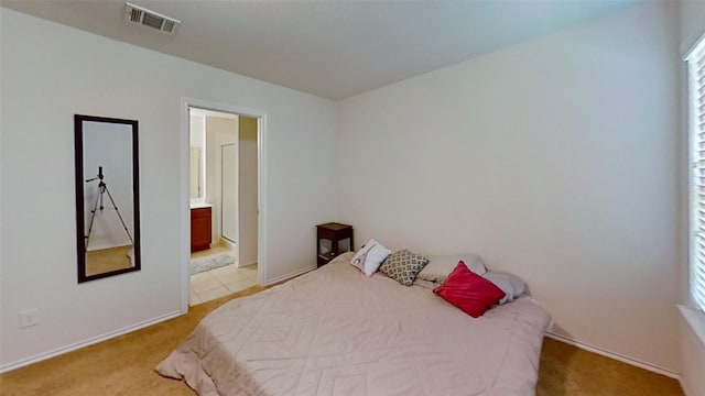 bedroom featuring light carpet