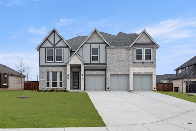 view of front of home with a garage, a shingled roof, concrete driveway, fence, and a front yard