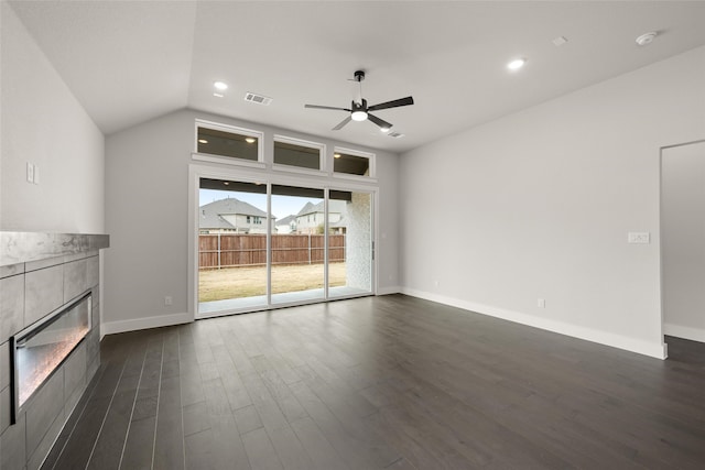 unfurnished living room featuring ceiling fan, dark wood-type flooring, a fireplace, and lofted ceiling