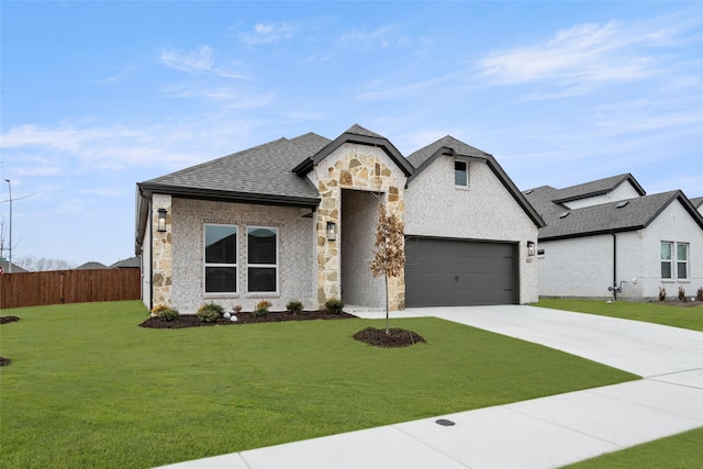 french country inspired facade featuring a garage and a front yard