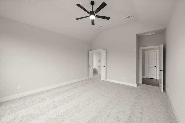 unfurnished bedroom featuring ceiling fan, light colored carpet, and vaulted ceiling