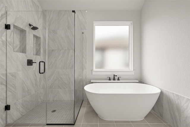 bathroom with tile patterned flooring and plus walk in shower