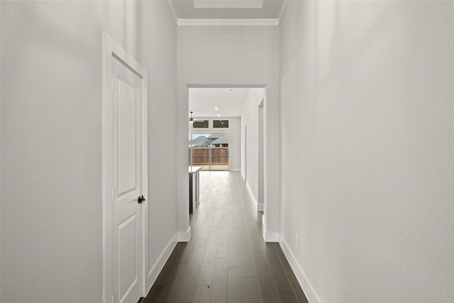 corridor featuring dark hardwood / wood-style floors and crown molding