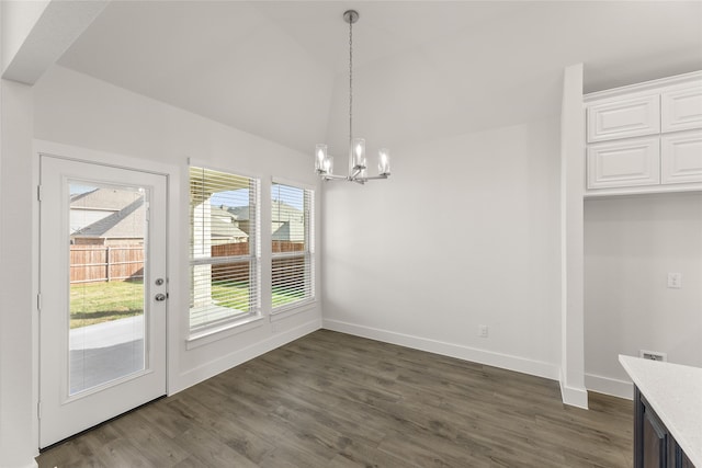 unfurnished dining area with dark hardwood / wood-style floors and an inviting chandelier