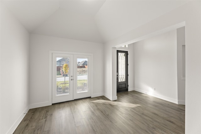 foyer entrance with french doors, dark hardwood / wood-style floors, and vaulted ceiling