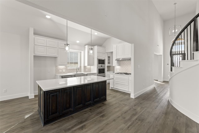 kitchen featuring a center island, decorative light fixtures, plenty of natural light, and appliances with stainless steel finishes