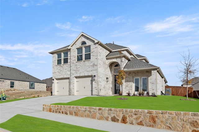 view of front of property featuring french doors, a front lawn, and a garage