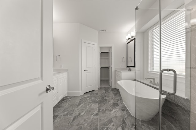 bathroom with a tub and vanity