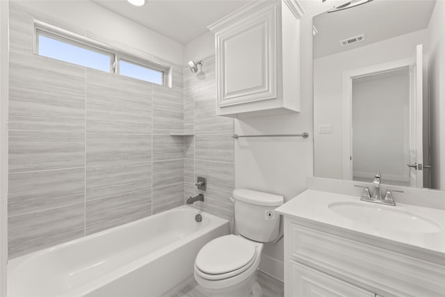 full bathroom with vanity, toilet, and tiled shower / bath