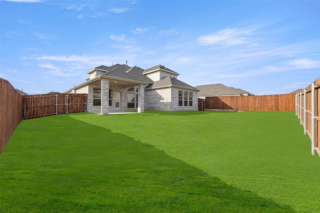 rear view of house with a yard