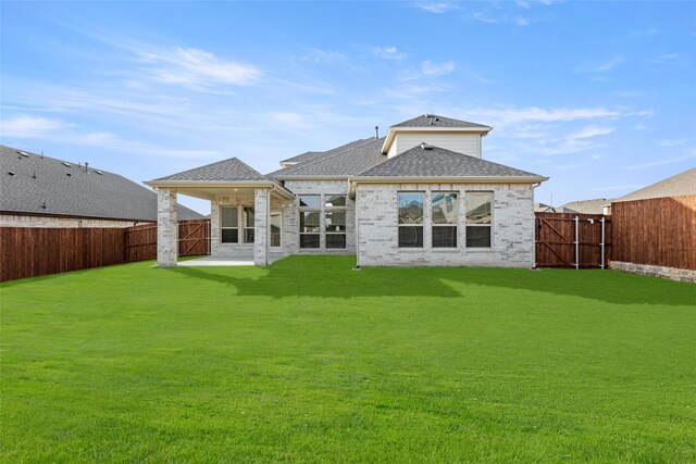 back of house featuring a yard and a patio