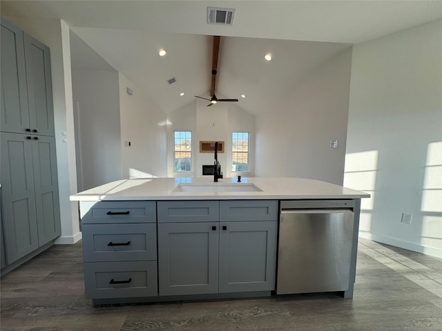 kitchen with dishwasher, sink, gray cabinetry, and an island with sink