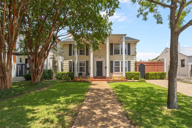 greek revival house featuring a front lawn