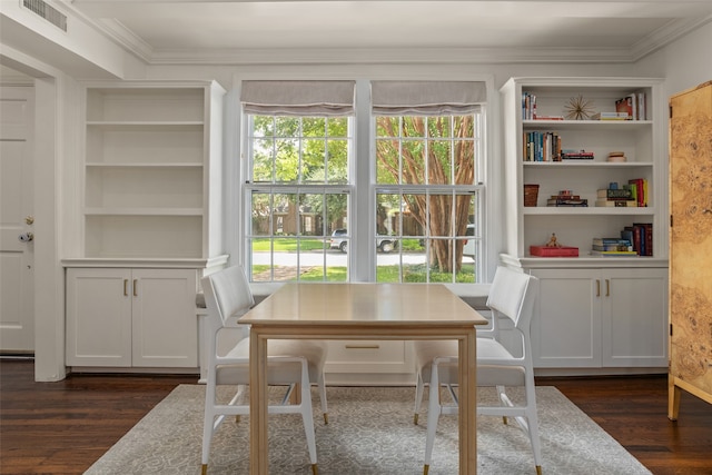 dining space with ornamental molding, built in shelves, and dark hardwood / wood-style floors