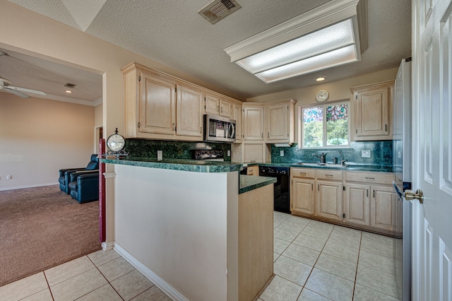 kitchen featuring appliances with stainless steel finishes, decorative backsplash, light tile patterned floors, a textured ceiling, and sink