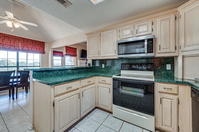 kitchen featuring appliances with stainless steel finishes, decorative backsplash, a textured ceiling, and light tile patterned floors