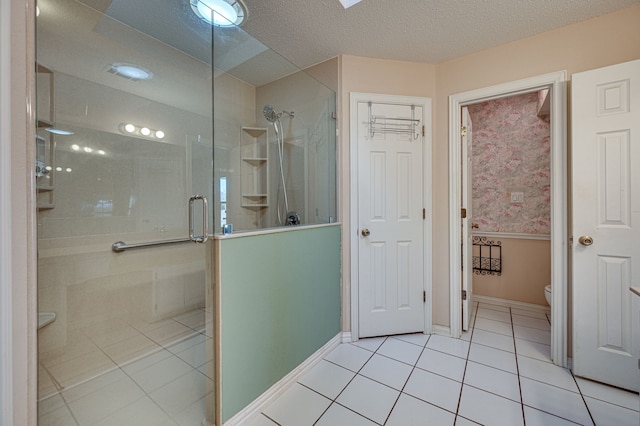 bathroom with tile patterned floors, a textured ceiling, an enclosed shower, and toilet