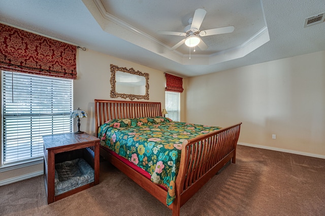 carpeted bedroom with multiple windows, a raised ceiling, ornamental molding, and ceiling fan