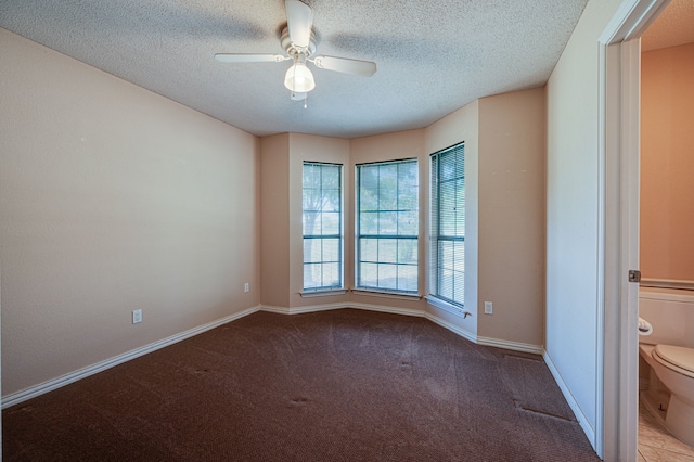 spare room with carpet floors, a textured ceiling, and ceiling fan