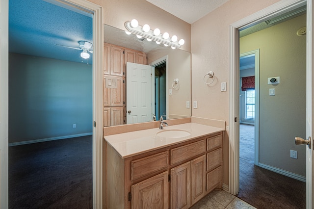 bathroom featuring vanity, a textured ceiling, tile patterned flooring, and ceiling fan