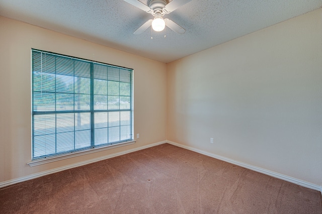 carpeted empty room featuring ceiling fan and a textured ceiling