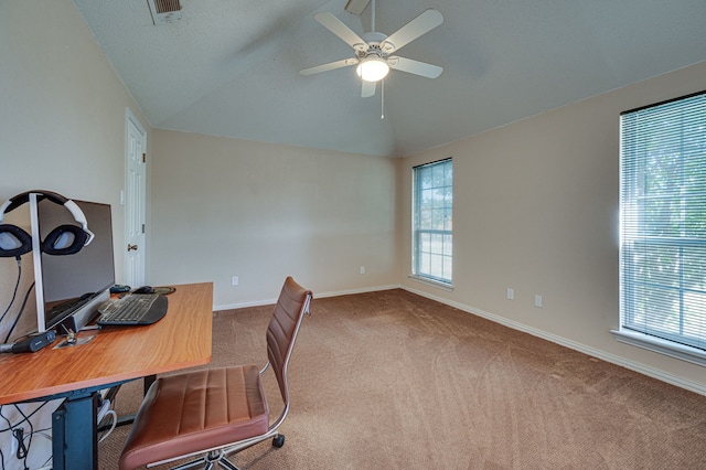 carpeted office space with ceiling fan, vaulted ceiling, and a healthy amount of sunlight