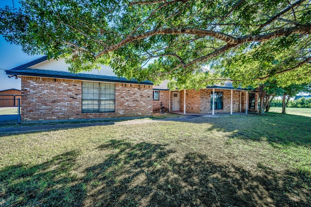 rear view of property with a lawn