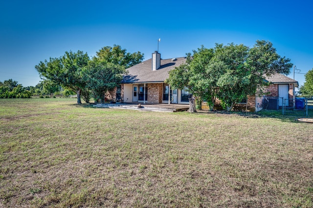 rear view of house with a lawn