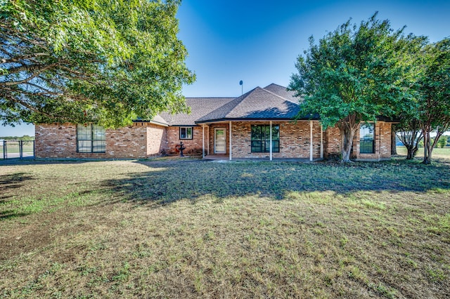 ranch-style home with a front lawn