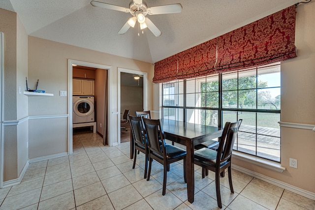 dining room with washer / dryer, a textured ceiling, lofted ceiling, light tile patterned floors, and ceiling fan