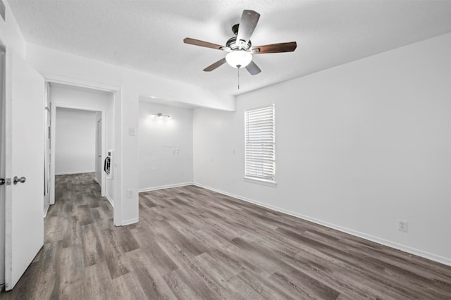 unfurnished room with ceiling fan, hardwood / wood-style floors, and a textured ceiling