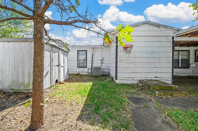 exterior space with a storage unit and central AC