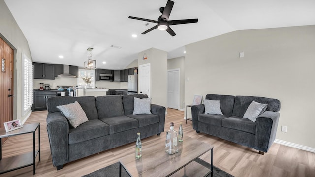 living area featuring lofted ceiling, light wood-style flooring, baseboards, and recessed lighting