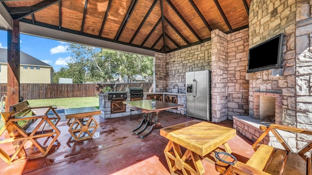 view of patio / terrace featuring area for grilling, a gazebo, sink, and an outdoor stone fireplace