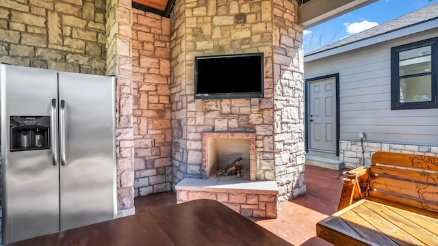 view of patio featuring an outdoor stone fireplace