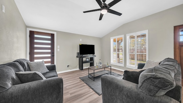 living room with wood-type flooring, vaulted ceiling, and ceiling fan