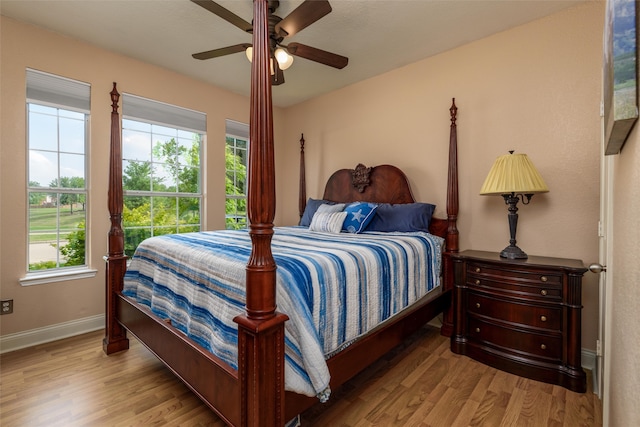 bedroom with light wood-type flooring and ceiling fan